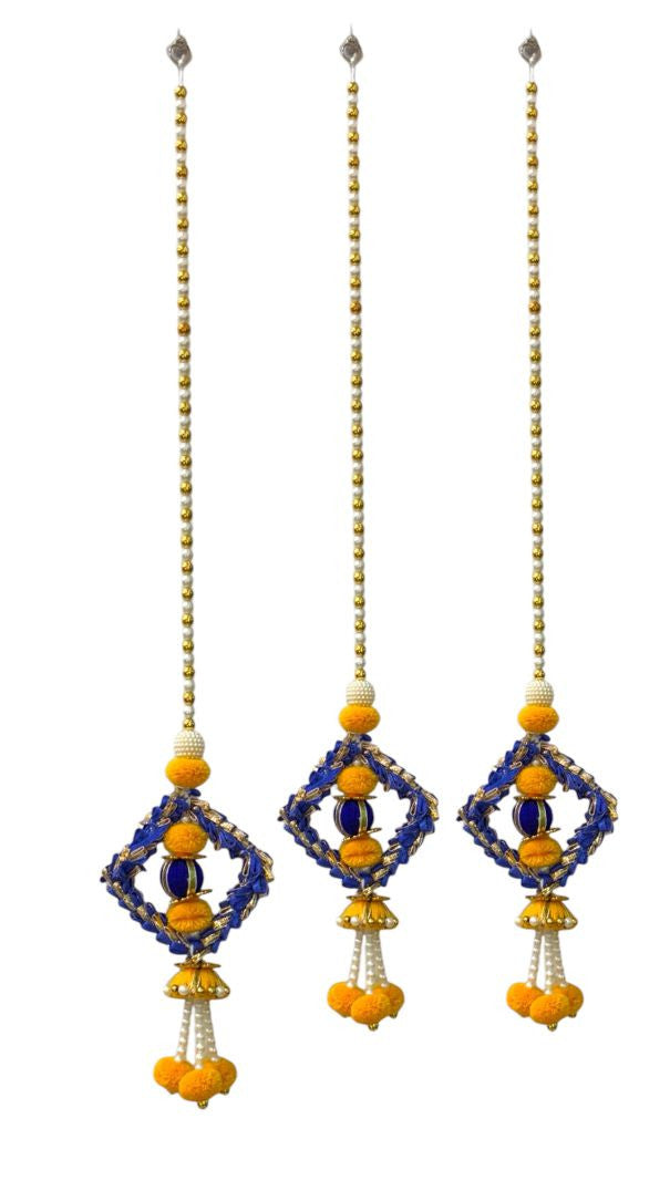 Three decorative hanging ornaments with blue, yellow, and white beads on a white background