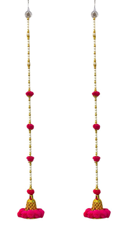 Long pink earrings with gold and red beads on a white background