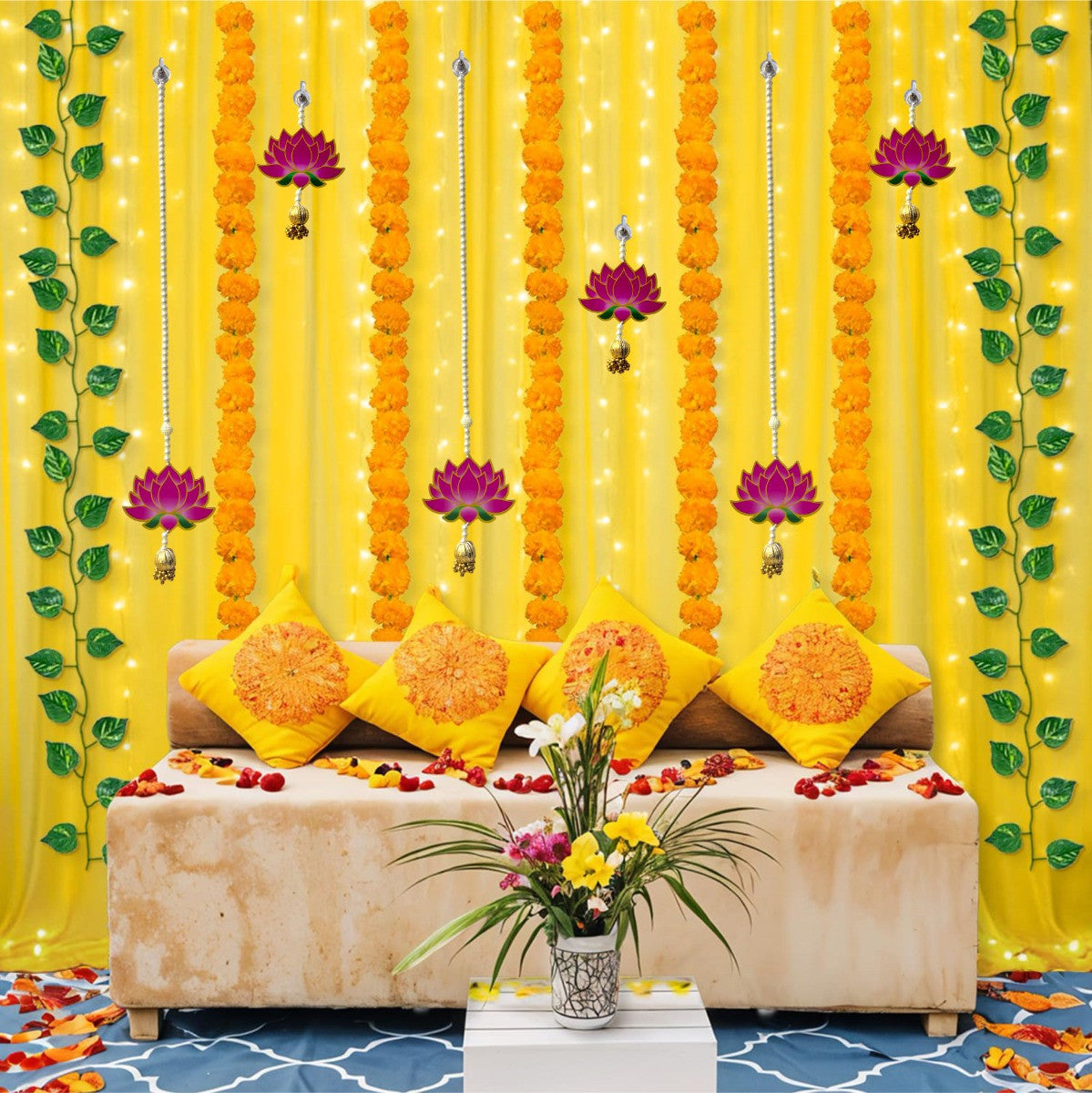 Decorative setup with yellow curtains, floral arrangements, and a sofa.