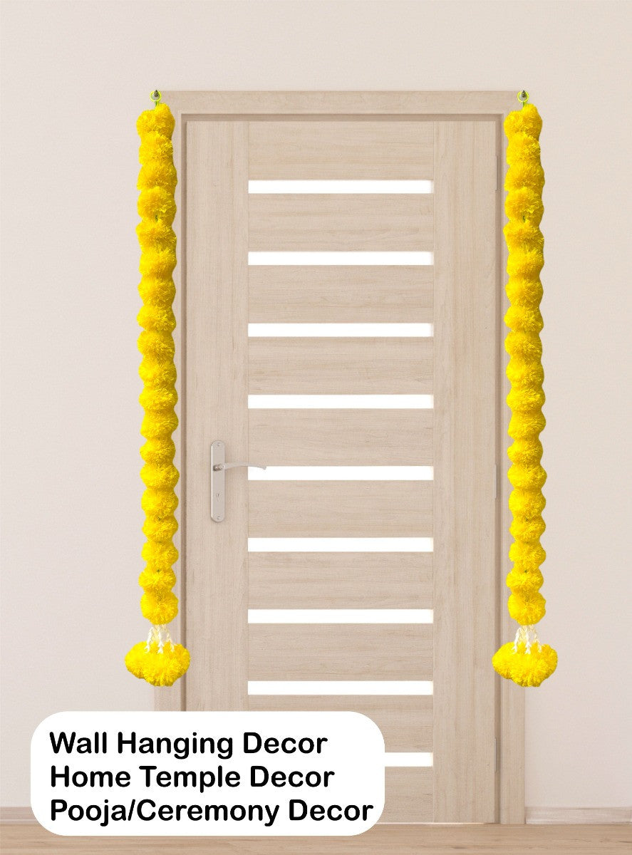 Yellow wall hanging decor on a door with text indicating use for home temple, pooja, and ceremony decor.